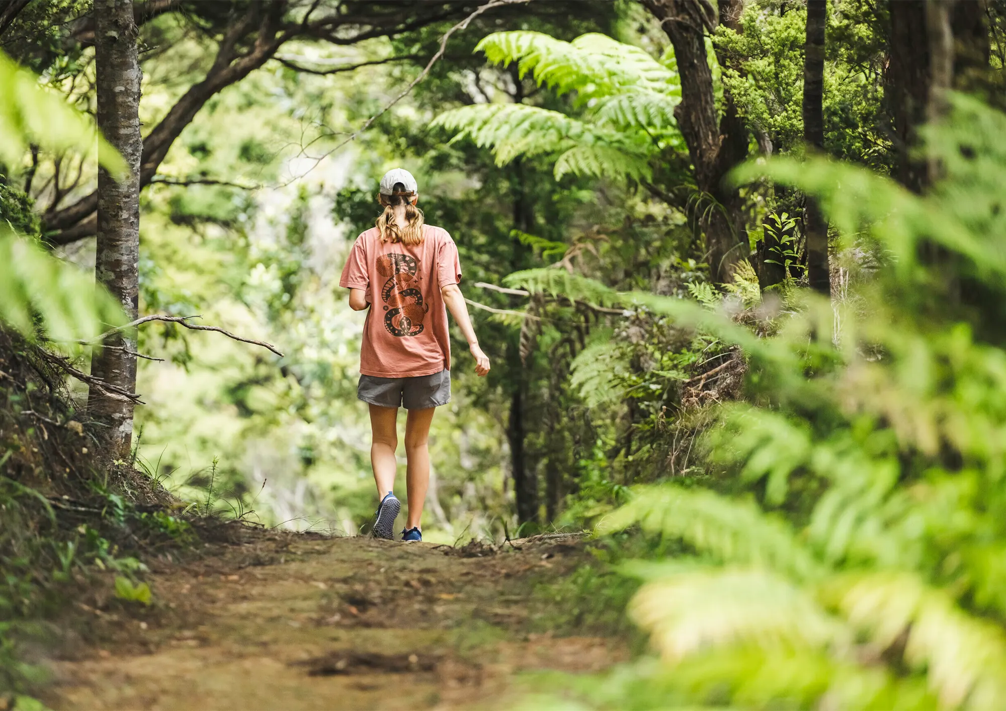 A girl hiking in New Zealand Native bush